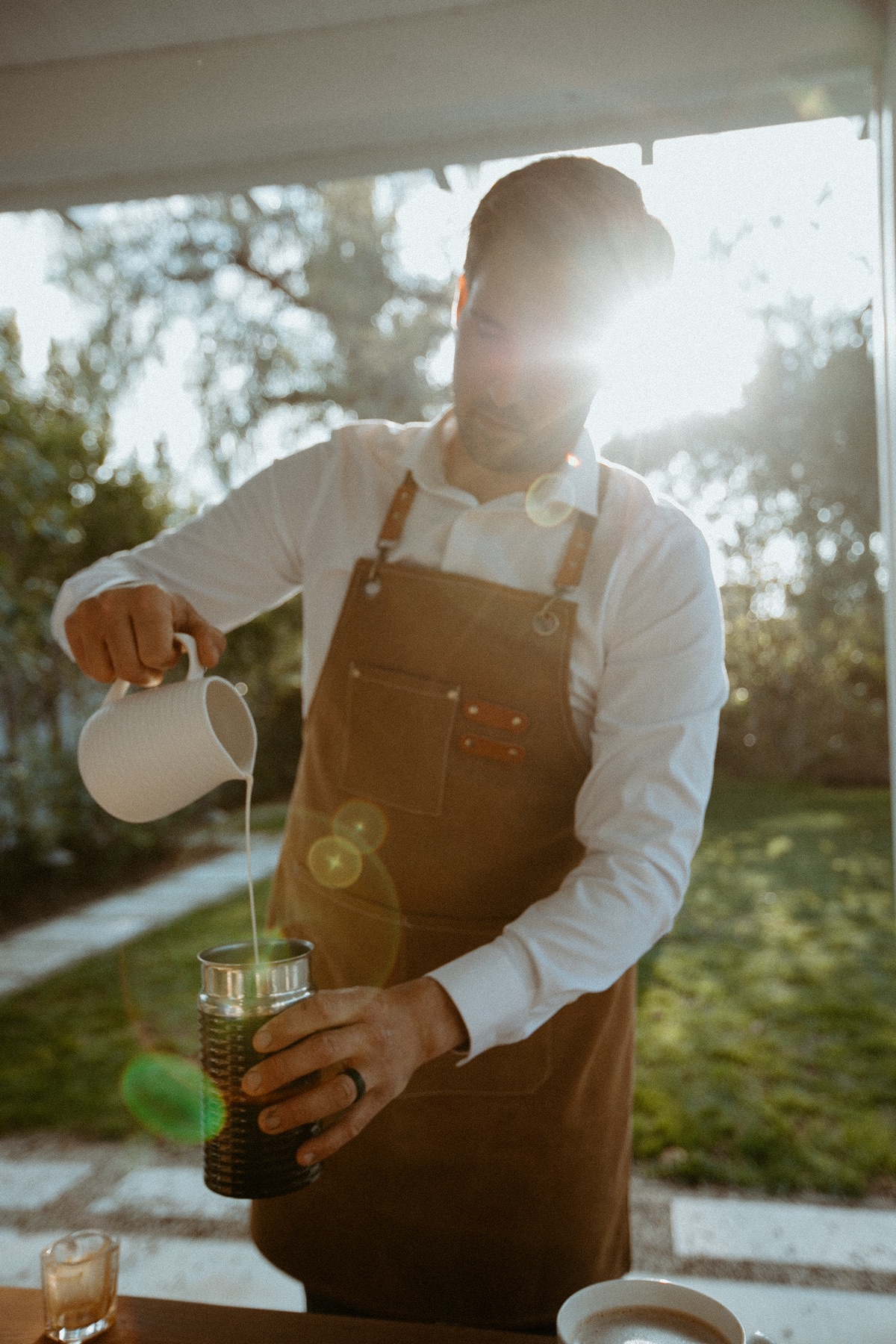 Homegrown barista frothing milk at an outdoor event