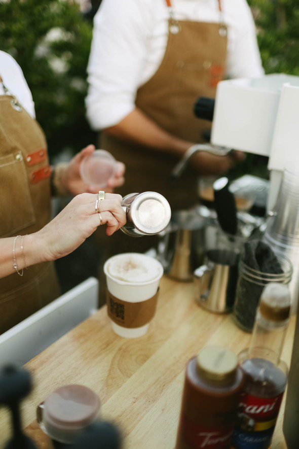 Homegrown barista finishing a latte at the coffee cart