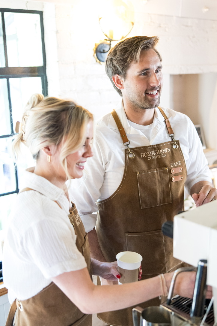 Two Homegrown baristas serving guests at the espresso machine