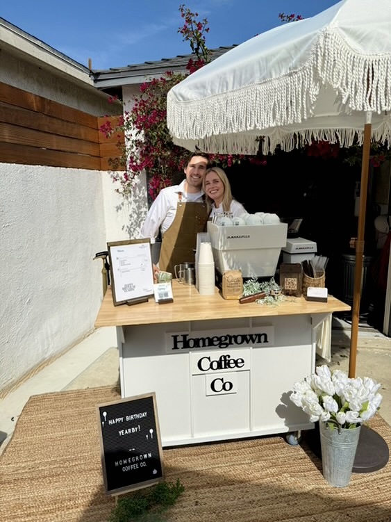 Dane and Caitlin behind the Homegrown coffee cart at an outdoor event