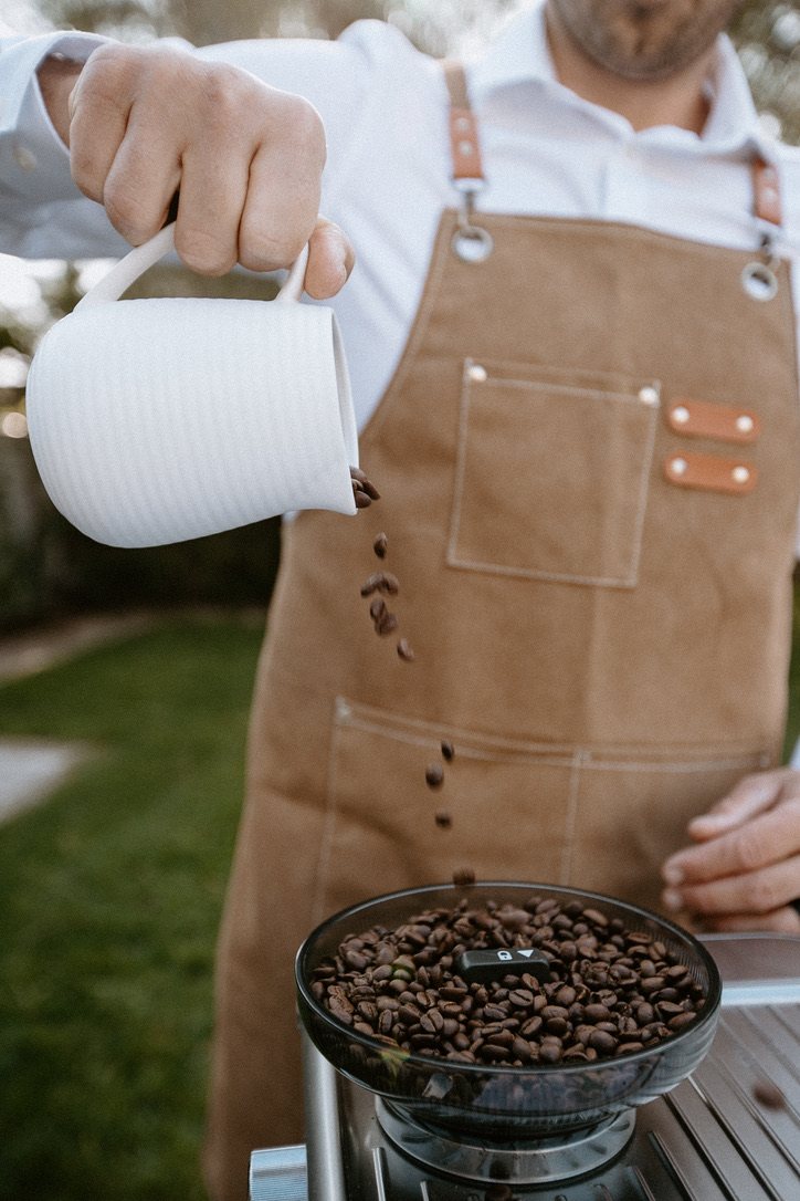 Coffee beans pouring into the grinder at a Homegrown event