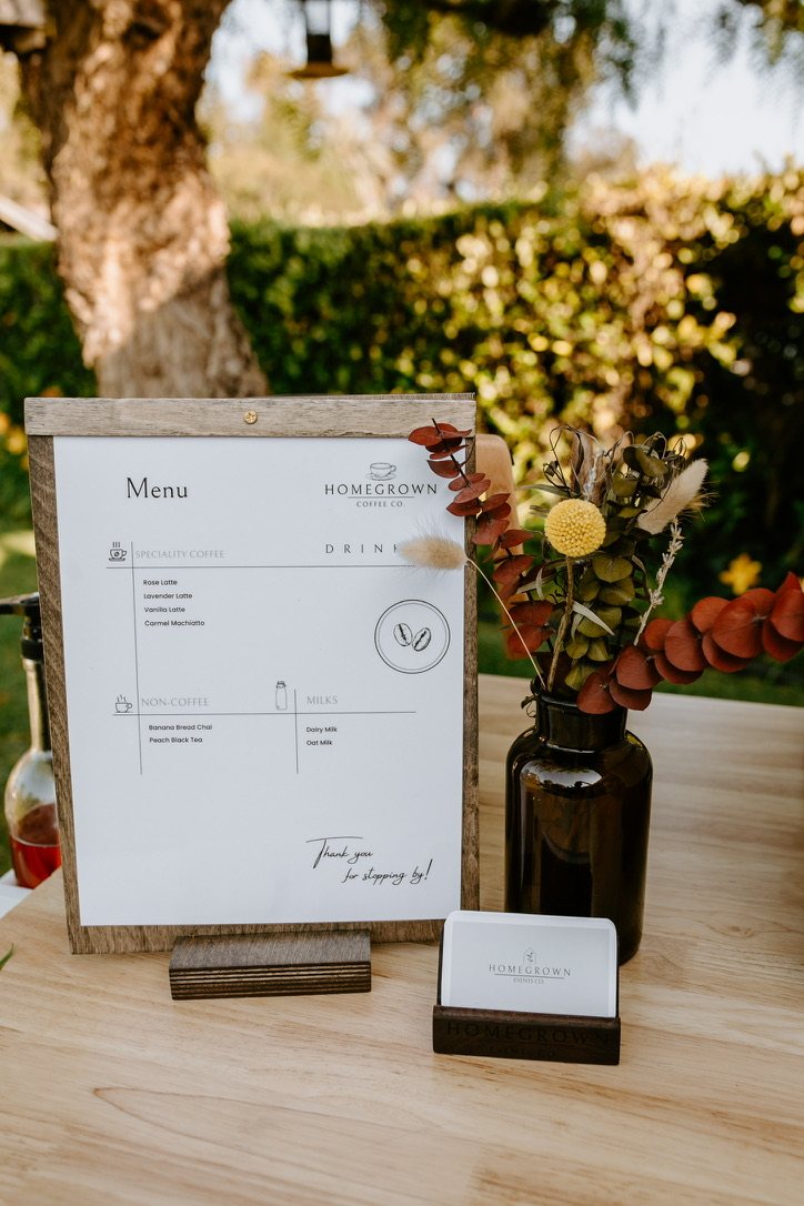 Custom Homegrown drink menu styled with florals at an outdoor event