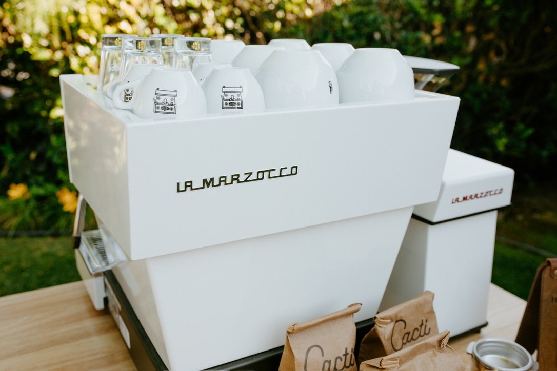 White La Marzocco espresso machine with branded Homegrown cups