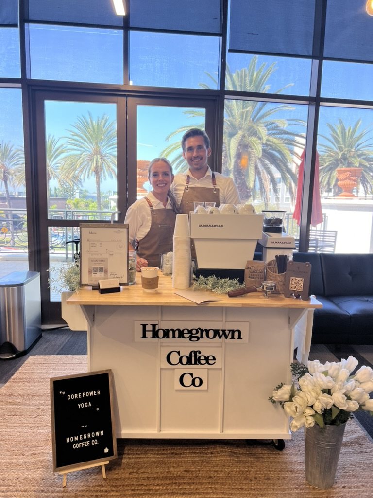 Dane and Caitlin behind the Homegrown coffee cart at a corporate event