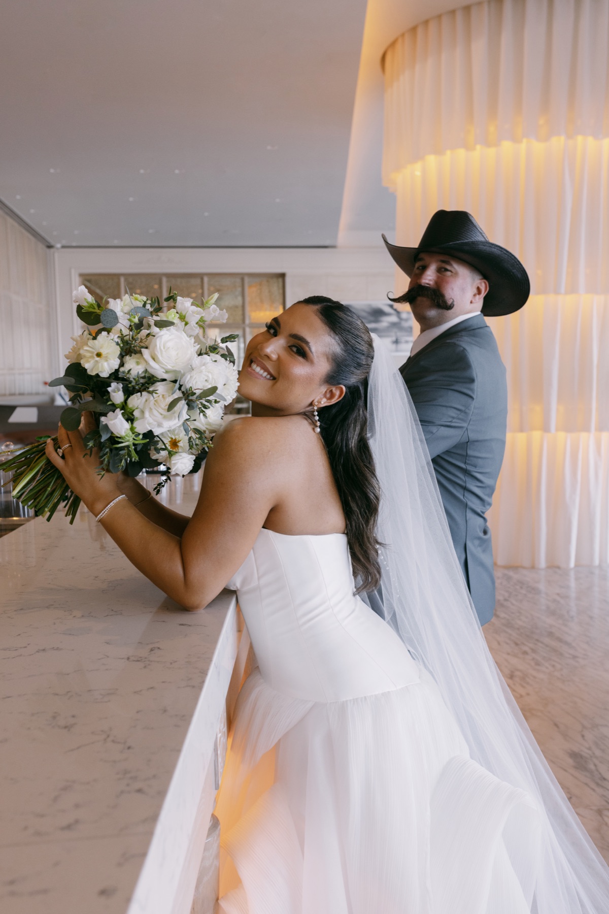 Bride and groom sharing a playful portrait at their reception