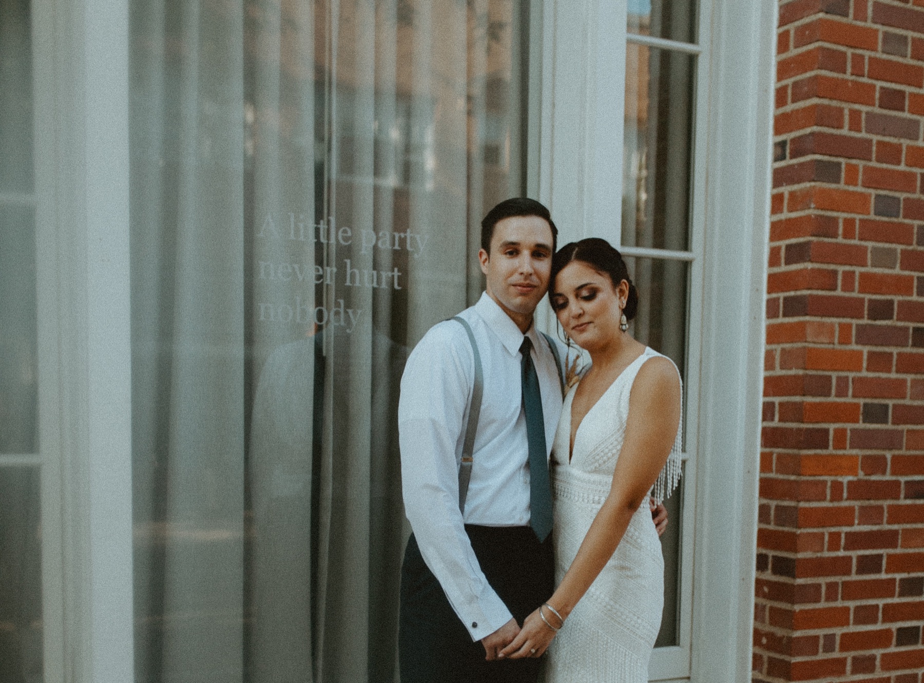 Newlyweds photographed together outside their venue