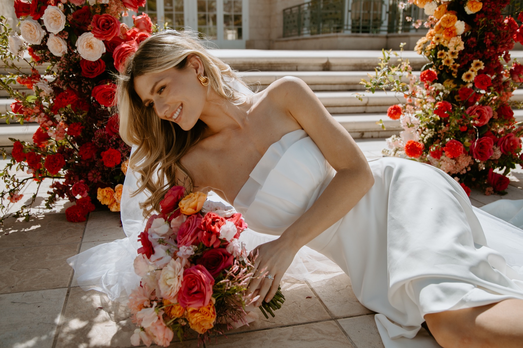 Bride photographed among vivid floral arrangements